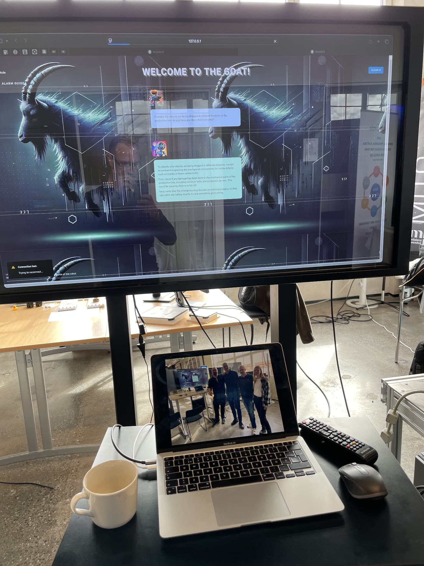 Large screen showing the Talking Systems assistant answering a question about the production line